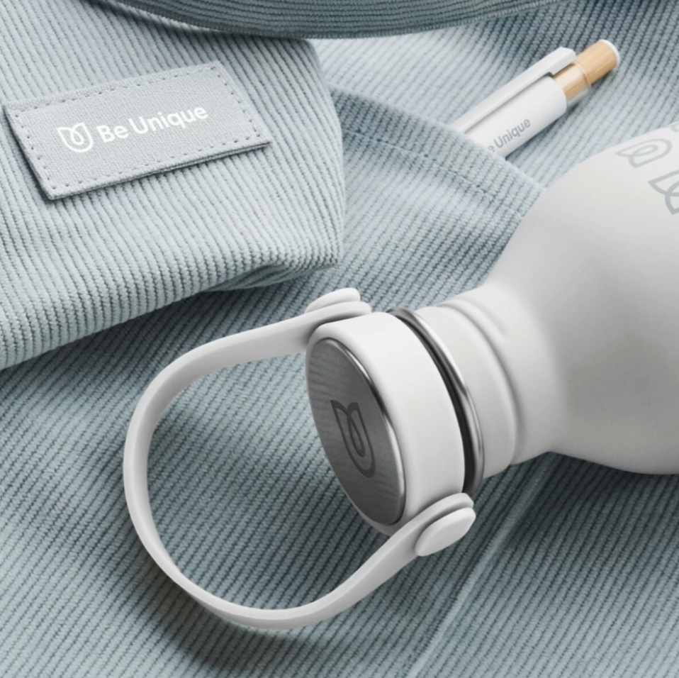 Branded white water bottle, pen and apparel label