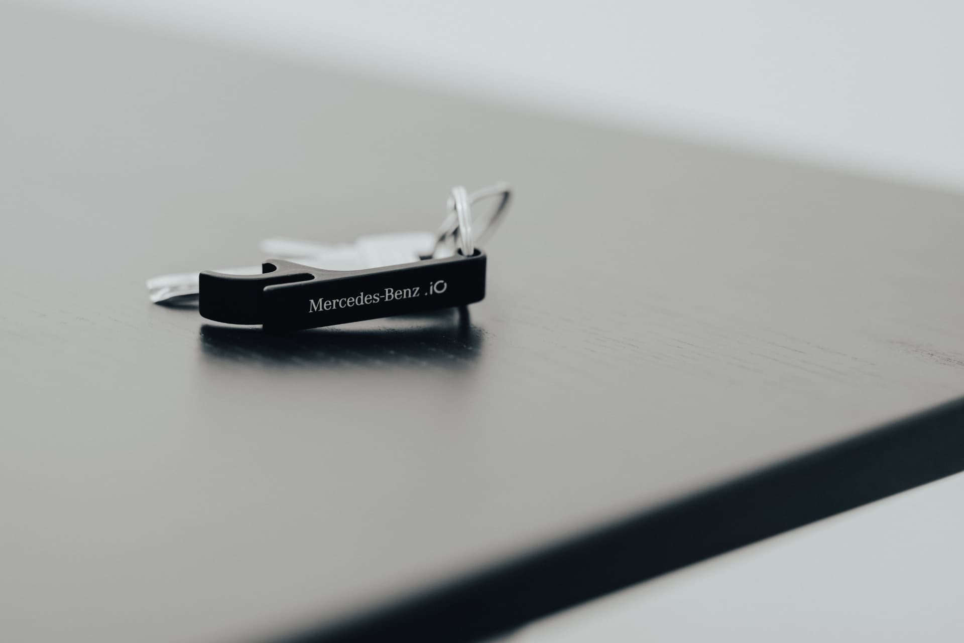 Mercedes-Benz .iO engraved black metal bottle-opener keyring